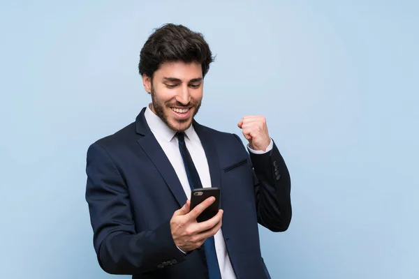 Businessman Isolated Blue Wall Phone Victory Position — Stock Photo, Image