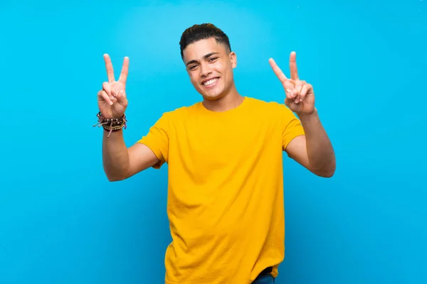 Junger Mann Mit Gelbem Hemd Vor Blauem Hintergrund Der Mit — Stockfoto