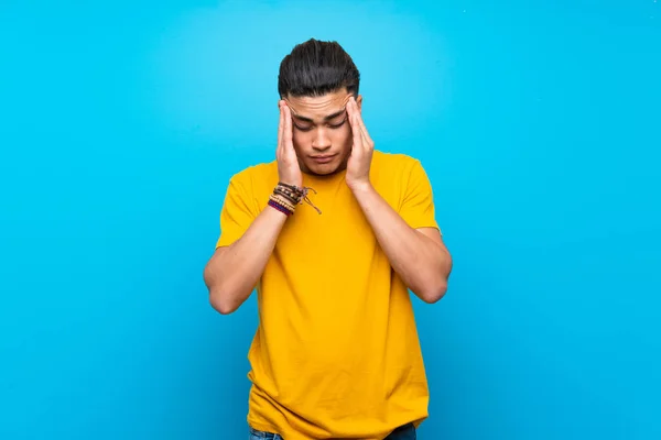 Young Man Yellow Shirt Isolated Blue Background Headache — Stok fotoğraf