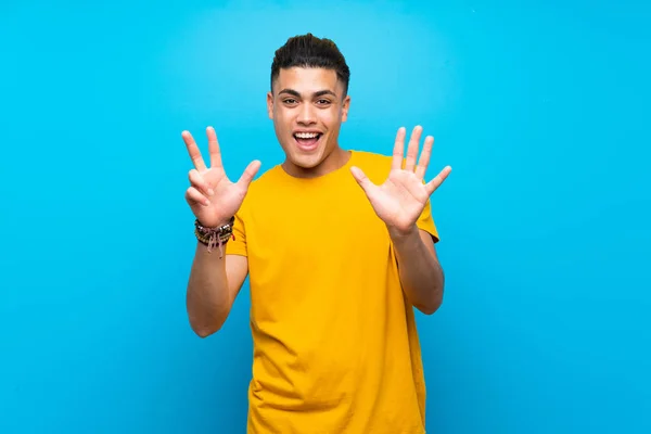 Young Man Yellow Shirt Isolated Blue Background Counting Eight Fingers — Stok fotoğraf