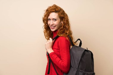 Sırt çantası ile boğazlı kazak ile Redhead kadın