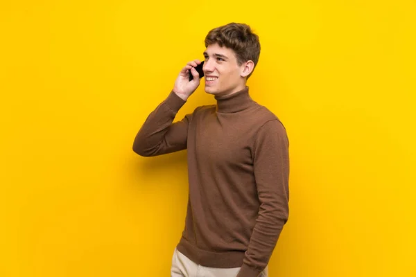 Handsome Young Man Isolated Yellow Background Keeping Conversation Mobile Phone — Stock Photo, Image