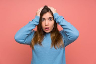 Sürpriz yüz ifadesi ile mavi kazaklı genç kız