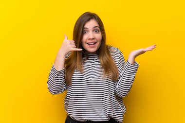 Sarı duvar üzerinde genç kız telefon jest yapma ve şüphe