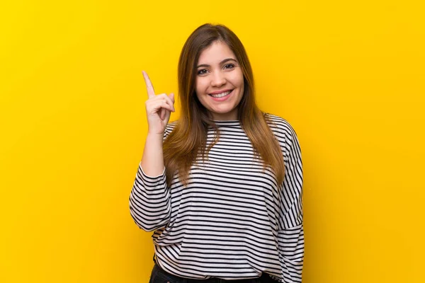 Young Girl Yellow Wall Showing Lifting Finger Sign Best — Stock Photo, Image