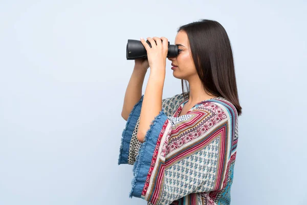 Mujer Joven Sobre Pared Azul Aislada Con Binoculares Negros —  Fotos de Stock