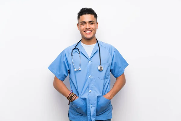 孤立した白い壁の上の若い外科医の医者の男はたくさん微笑む — ストック写真