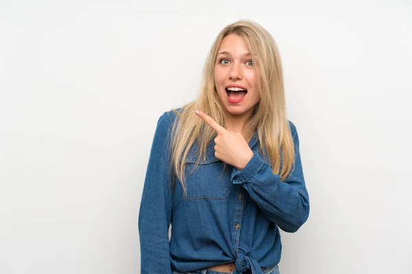 Young Blonde Woman Isolated White Wall Surprised Pointing Side — Stock Photo, Image