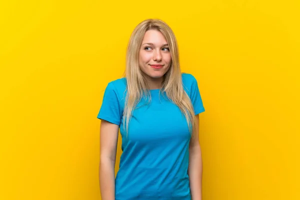 Young Blonde Woman Isolated Yellow Background Making Doubts Gesture Looking — Stock Photo, Image