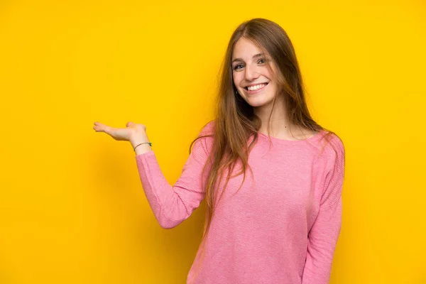Young Woman Long Hair Isolated Yellow Wall Holding Copyspace Imaginary — Stock Photo, Image