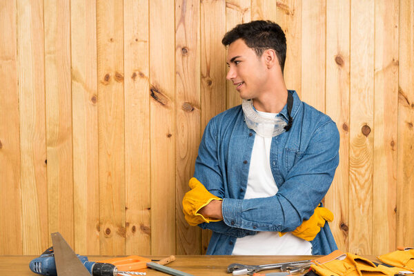 Craftsmen man over wood background laughing