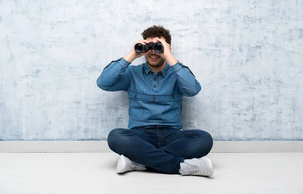 Young Man Sitting Floor Black Binoculars — Stock Photo, Image