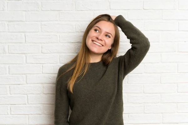 白いレンガの壁の上の若い女性笑い — ストック写真