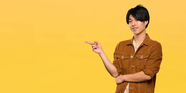 Asian Man Brown Jacket Pointing Finger Side Isolated Yellow Background — Stock Photo, Image