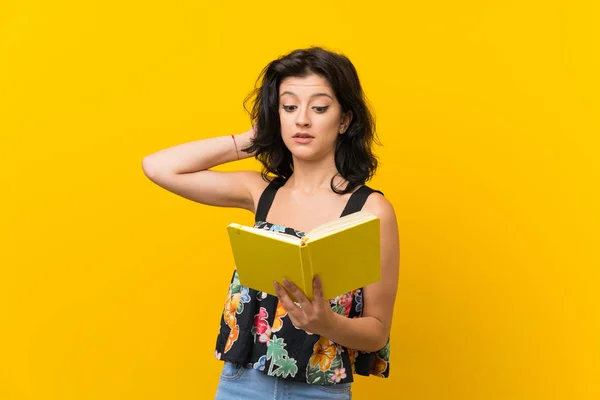 Young Woman Isolated Yellow Background Holding Reading Book — Stock Photo, Image