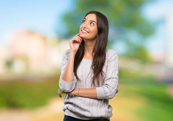 Young Hispanic Brunette Woman Thinking Idea While Looking Outdoors — Stock Photo, Image