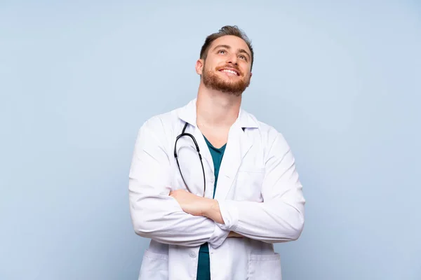 Handsome Doctor Man Blue Wall Looking While Smiling — Stock Photo, Image