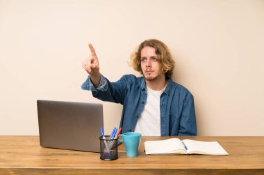 Şeffaf ekrana dokunan bir dizüstü bilgisayar ile Sarışın adam