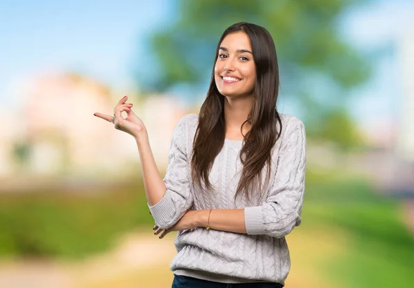 Young Hispanic Brunette Woman Pointing Finger Side Outdoors — Stock Photo, Image