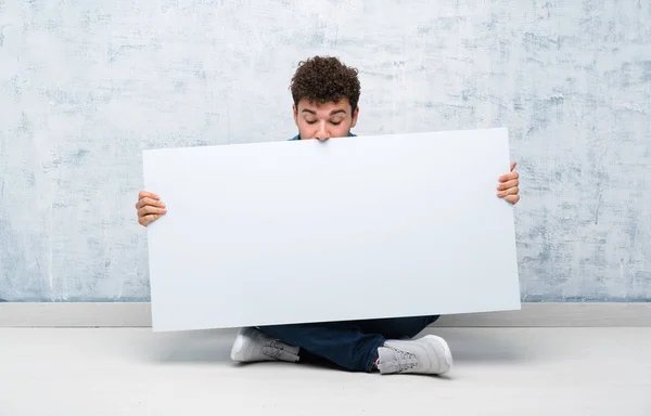 Young Man Sitting Floor Holding Empty White Placard Insert Concept — Stock Photo, Image