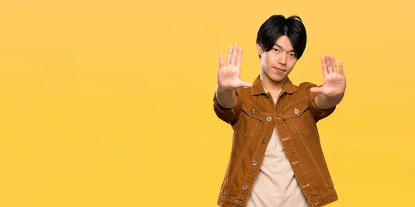 Asian Man Brown Jacket Making Stop Gesture Disappointed Isolated Yellow — Stock Photo, Image