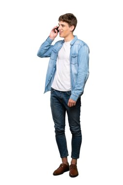 Izole beyaz arka plan üzerinde cep telefonu ile bir konuşma tutan yakışıklı bir genç adam tam uzunlukta bir çekim