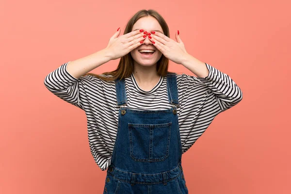 Młoda Kobieta Kombinezonu Nad Różową Ścianę Pokrywającą Oczy Rękami Zaskoczony — Zdjęcie stockowe