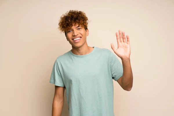 African American Man Green Shirt Saluting Hand Happy Expression — Stock Photo, Image