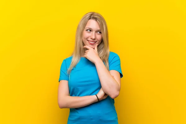 Jonge Blonde Vrouw Geïsoleerde Gele Achtergrond Zoek Naar Zijkant — Stockfoto