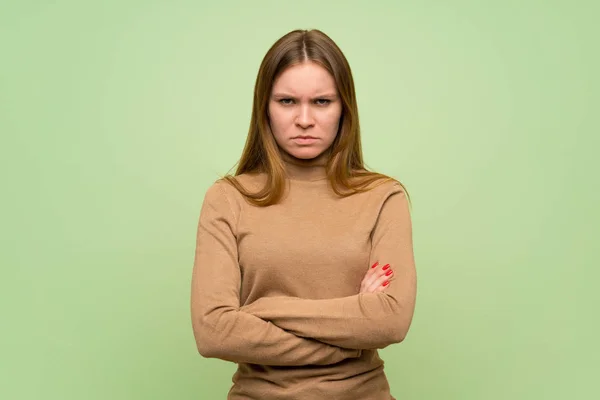 Young woman with turtleneck sweater feeling upset