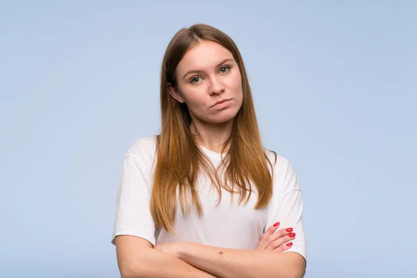 Young woman over blue wall portrait