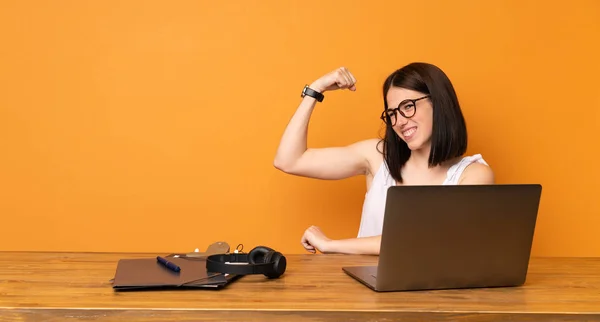 Business woman in a office doing strong gesture