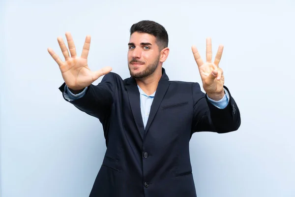 Hombre Guapo Sobre Fondo Azul Aislado Contando Ocho Con Los — Foto de Stock