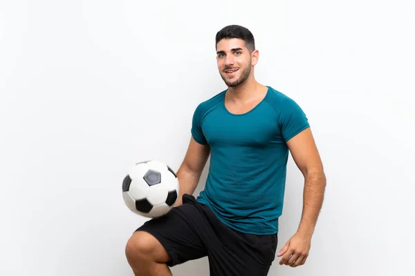 孤立した白い壁の上にハンサムな若いサッカー選手の男 — ストック写真
