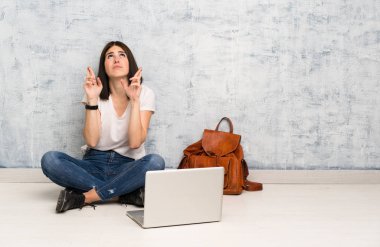 Öğrenci kadın parmakları ile yere oturan geçiş ve en iyi dilek