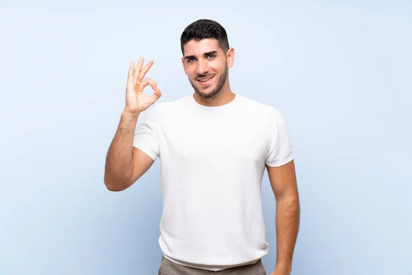 Kavkazský Pohledný Muž Přes Izolované Modré Pozadí Ukazující Znamení Prsty — Stock fotografie