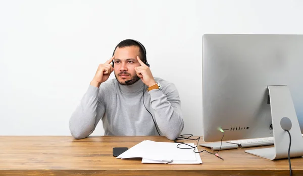 Telemarketer Colombian man having doubts and thinking