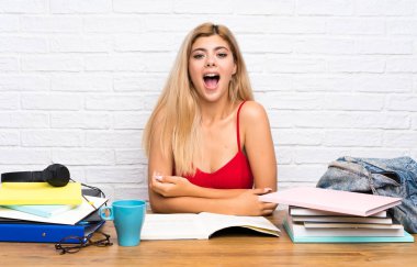 Teenager student girl at indoors with surprise facial expression clipart