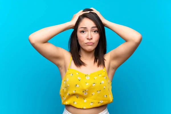 Young Mexican woman over isolated blue background with surprise facial expression