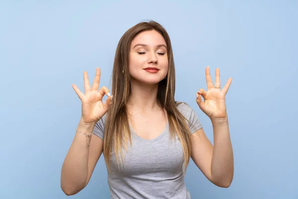 Adolescente Chica Sobre Aislado Azul Pared Zen Pose —  Fotos de Stock