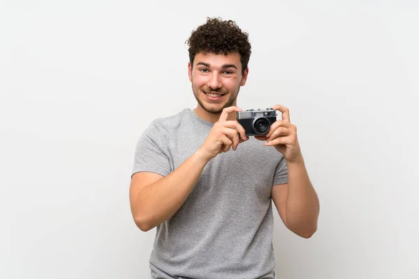 Man Curly Hair Isolated Wall Holding Camera — Stock Photo, Image