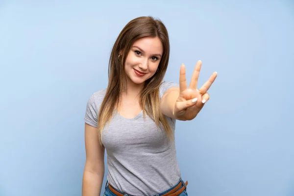 Adolescente Chica Sobre Aislado Azul Pared Feliz Contar Tres Con —  Fotos de Stock