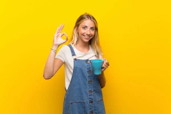 Blonde Jonge Vrouw Geïsoleerde Gele Achtergrond Houden Hete Kopje Koffie — Stockfoto
