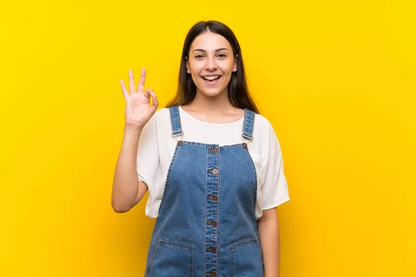 Giovane Donna Salopette Isolato Sfondo Giallo Sorpreso Mostrando Segno — Foto Stock