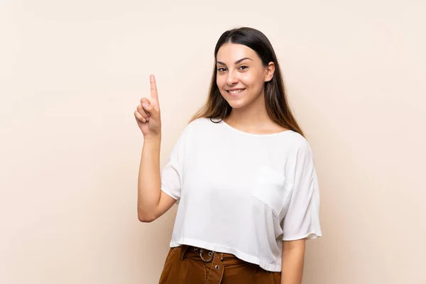 Młoda Brunetka Kobieta Białym Tle Pokazując Podnosząc Palec Znaku Najlepszego — Zdjęcie stockowe