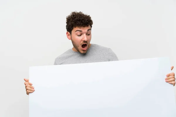 Homme Aux Cheveux Bouclés Dessus Mur Isolé Tenant Une Plaque — Photo