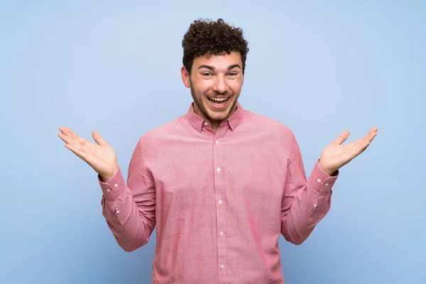 Man Curly Hair Isolated Blue Wall Shocked Facial Expression — Stock Photo, Image