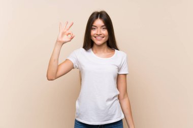 Parmakları ile ok işareti gösteren izole arka plan üzerinde Pretty genç kız