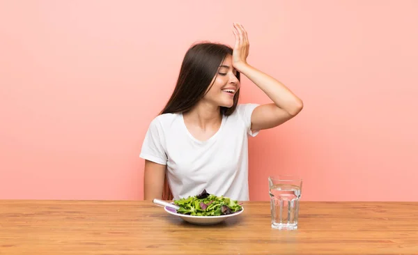 Young woman with a salad has realized something and intending the solution