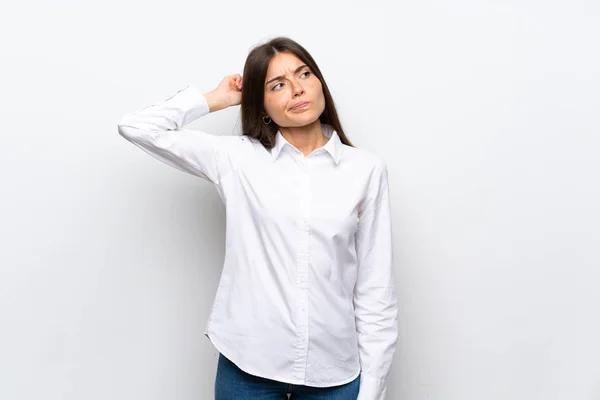 stock image Young woman over isolated white background having doubts and with confuse face expression